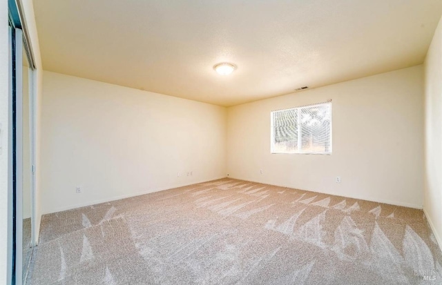 spare room with light carpet