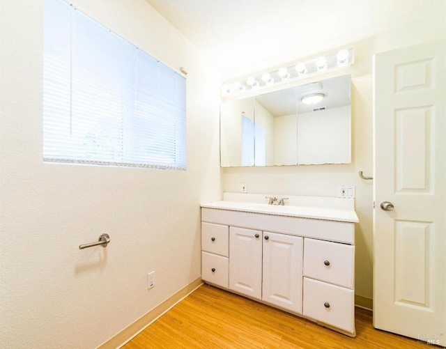 bathroom with vanity and hardwood / wood-style floors