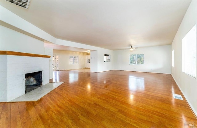 unfurnished living room featuring ceiling fan and light hardwood / wood-style flooring