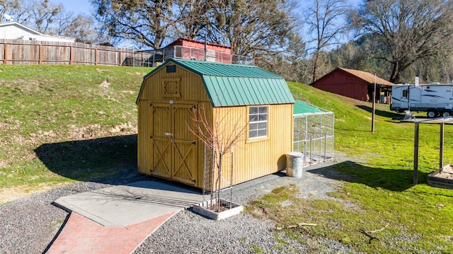 view of outbuilding with a yard