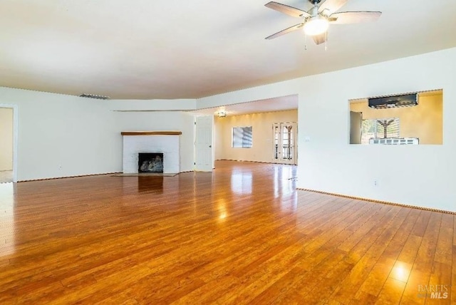 unfurnished living room featuring wood-type flooring and ceiling fan