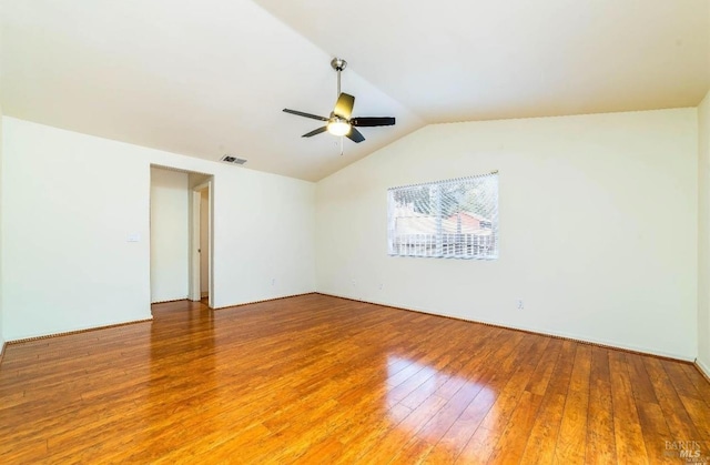 spare room featuring lofted ceiling, hardwood / wood-style floors, and ceiling fan