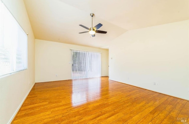 empty room featuring light hardwood / wood-style flooring, ceiling fan, and vaulted ceiling