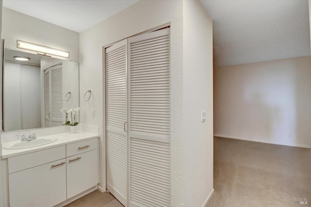 bathroom with a closet and vanity