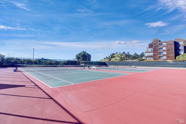 view of tennis court with fence