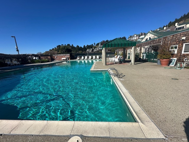 community pool featuring a gazebo and a patio