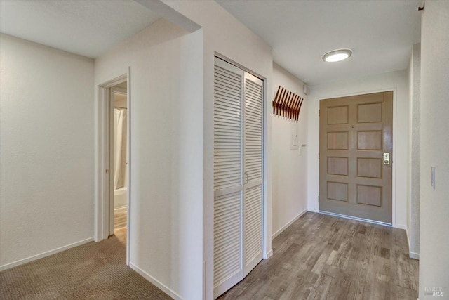 interior space featuring baseboards and wood finished floors