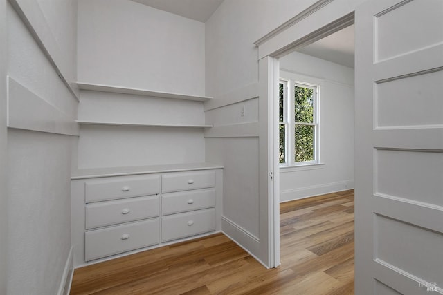 spacious closet featuring light wood-style flooring