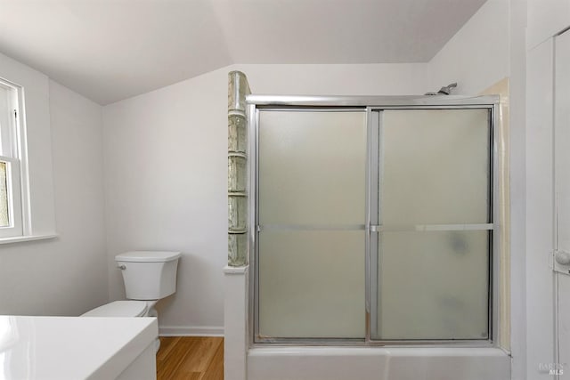 bathroom with vanity, vaulted ceiling, toilet, and wood finished floors