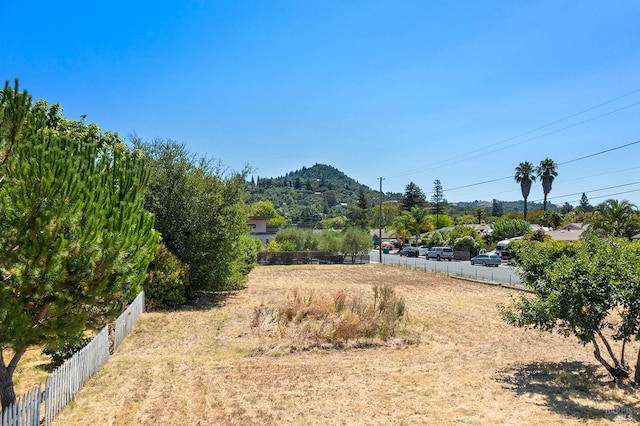 view of yard with a mountain view and fence