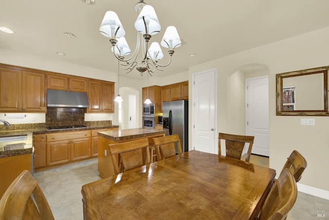 dining area with sink and a notable chandelier