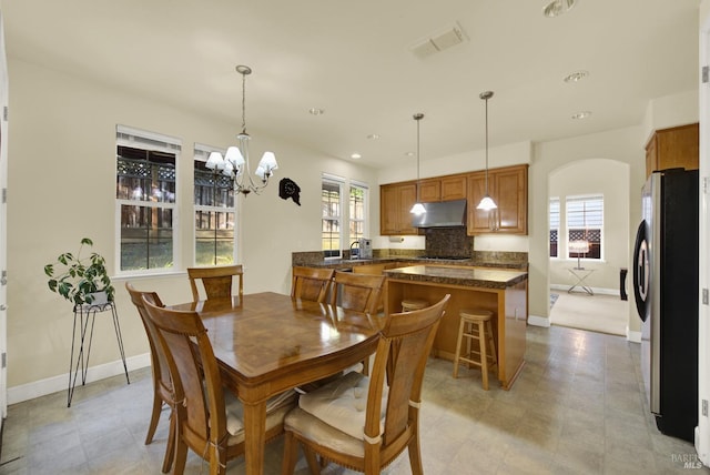 dining space featuring a wealth of natural light and a chandelier