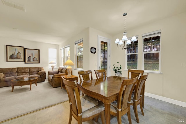 dining area with an inviting chandelier