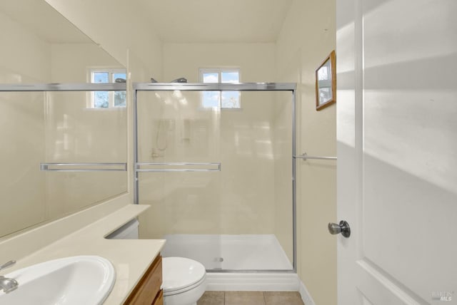 bathroom with vanity, plenty of natural light, an enclosed shower, and toilet