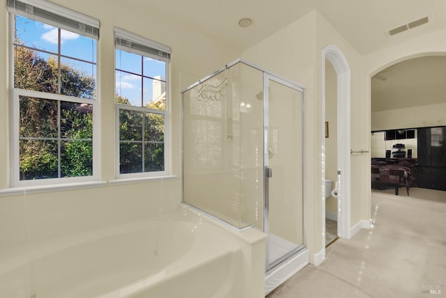 bathroom with shower with separate bathtub and toilet