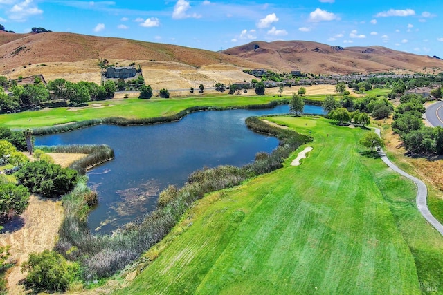 birds eye view of property with a water and mountain view