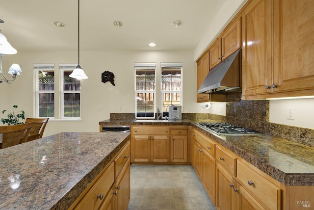 kitchen featuring tasteful backsplash, sink, decorative light fixtures, and stainless steel gas cooktop