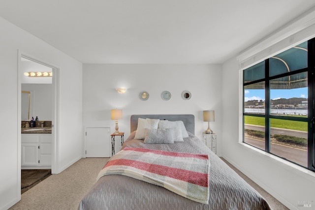 carpeted bedroom with connected bathroom