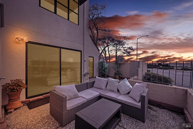 patio terrace at dusk featuring outdoor lounge area