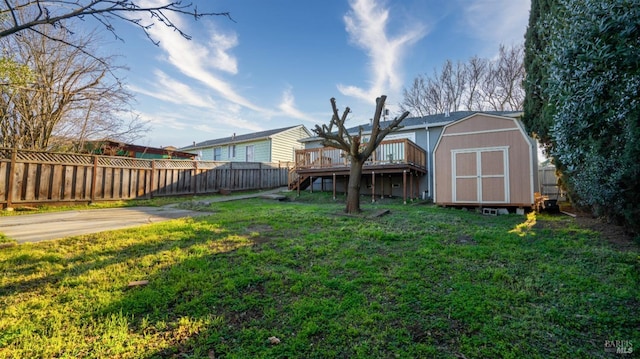 view of yard featuring a shed and a wooden deck