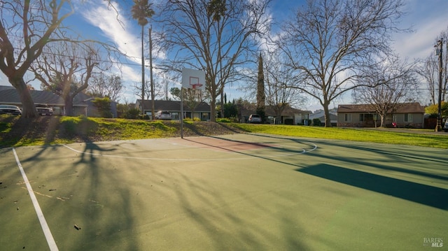 view of basketball court featuring a yard