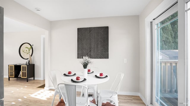 dining space with light hardwood / wood-style flooring