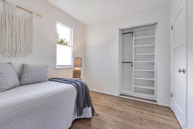 bedroom featuring baseboards and wood finished floors