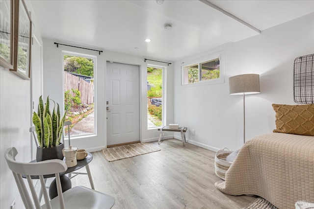 entryway with recessed lighting, baseboards, and wood finished floors