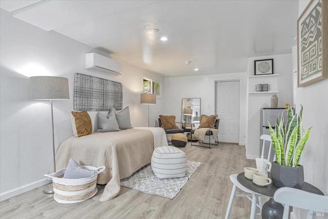 bedroom with recessed lighting, an AC wall unit, baseboards, and wood finished floors