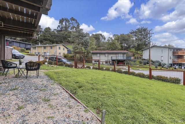 view of yard featuring fence and a residential view