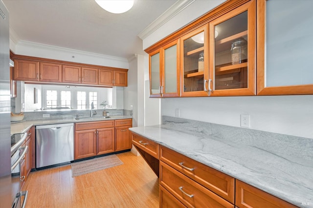 1300 Quarry Ct Unit 213, Richmond, CA 94801 - kitchen with crown molding, brown cabinets, a sink, light wood finished floors, and stainless steel appliances