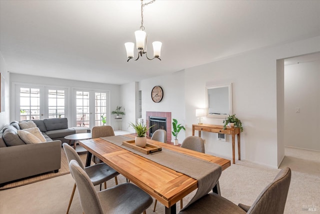 1300 Quarry Ct Unit 213, Richmond, CA 94801 - dining space with an inviting chandelier, light carpet, and a brick fireplace