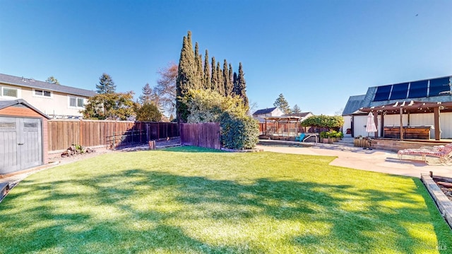 view of yard featuring a storage shed and a patio area