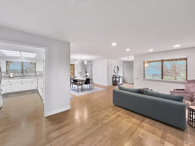 living room featuring sink and light hardwood / wood-style floors