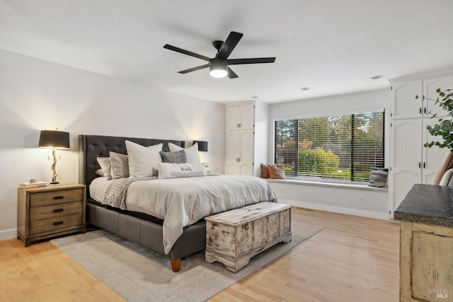 bedroom with light hardwood / wood-style floors and ceiling fan