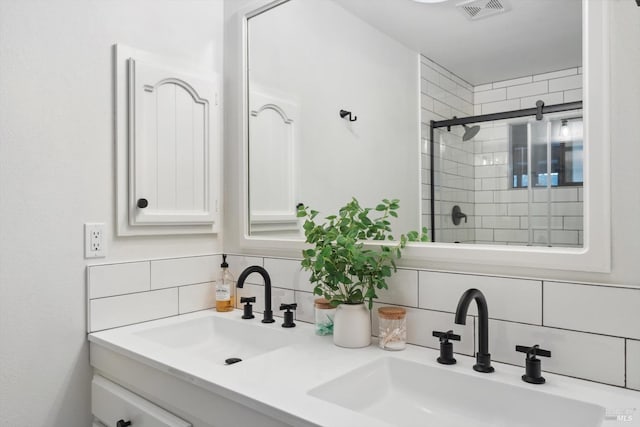 bathroom with tasteful backsplash, vanity, and a shower with shower door