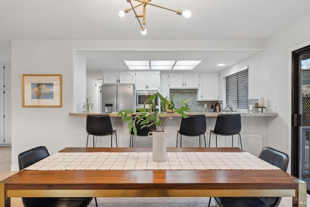 dining room featuring a skylight