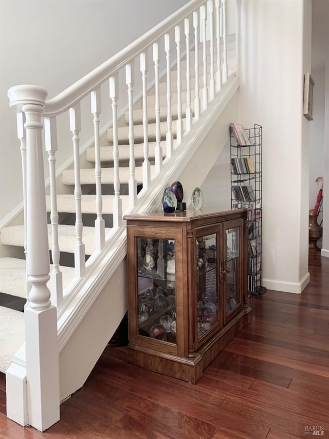 stairs featuring wood-type flooring