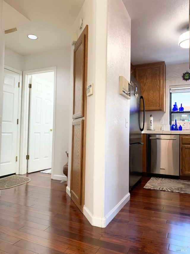 corridor with dark hardwood / wood-style flooring