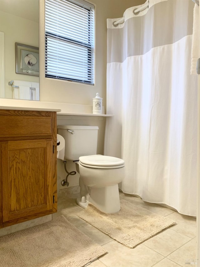 bathroom with vanity, tile patterned floors, and toilet