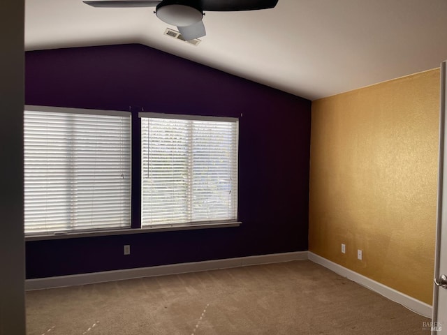 carpeted spare room with ceiling fan and lofted ceiling