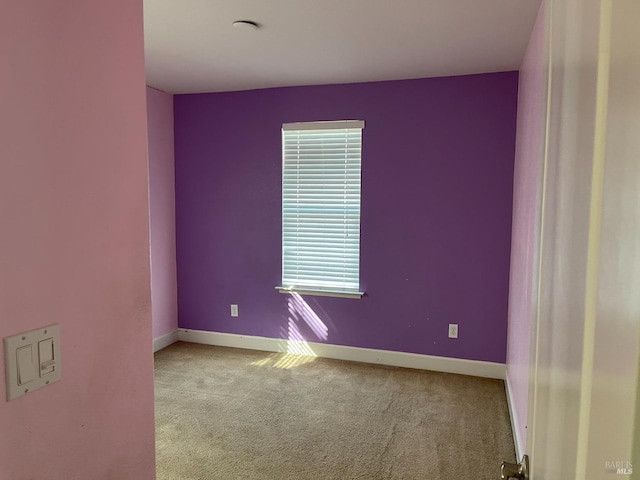 spare room with light colored carpet