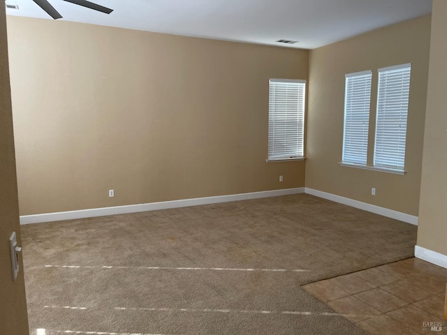 empty room featuring carpet floors and ceiling fan