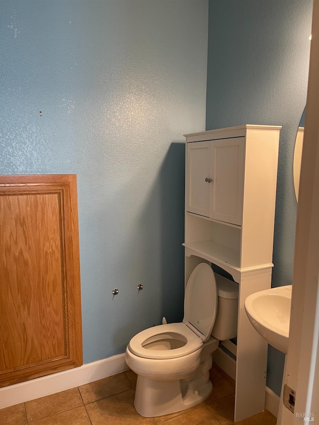 bathroom featuring tile patterned floors and toilet