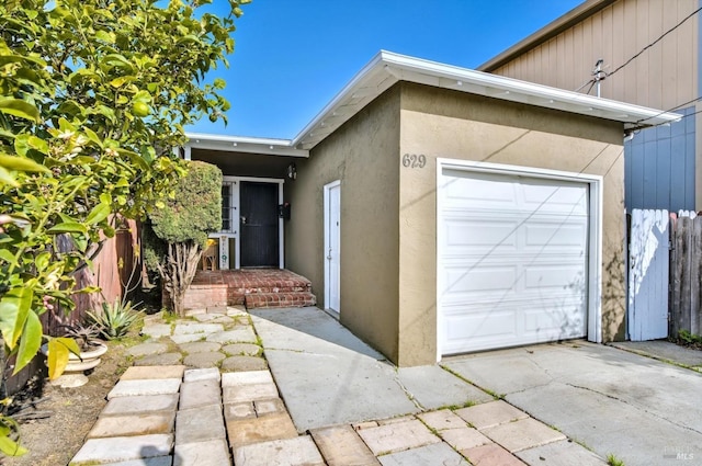 doorway to property with a garage