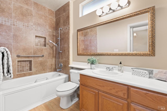 bathroom with shower / bath combination, visible vents, toilet, wood finished floors, and vanity