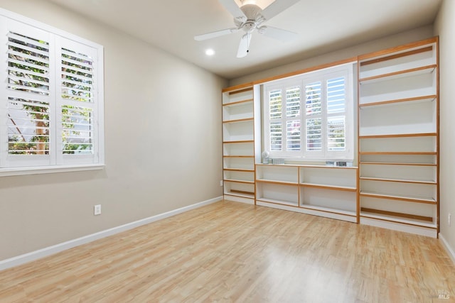 unfurnished room featuring recessed lighting, wood finished floors, a ceiling fan, and baseboards