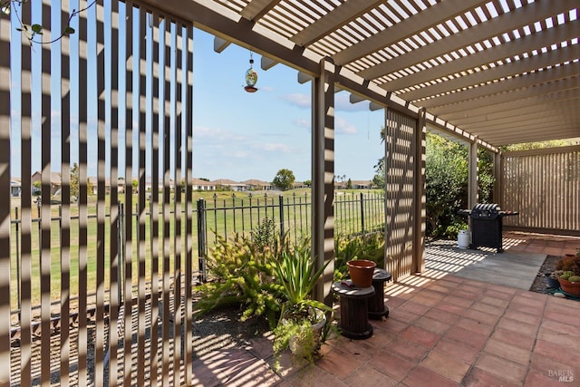 view of patio featuring area for grilling and a pergola