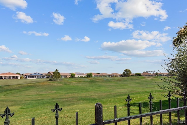 surrounding community featuring a yard, a rural view, and fence