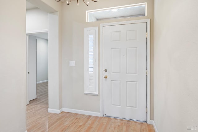 entrance foyer with an inviting chandelier and light wood-type flooring